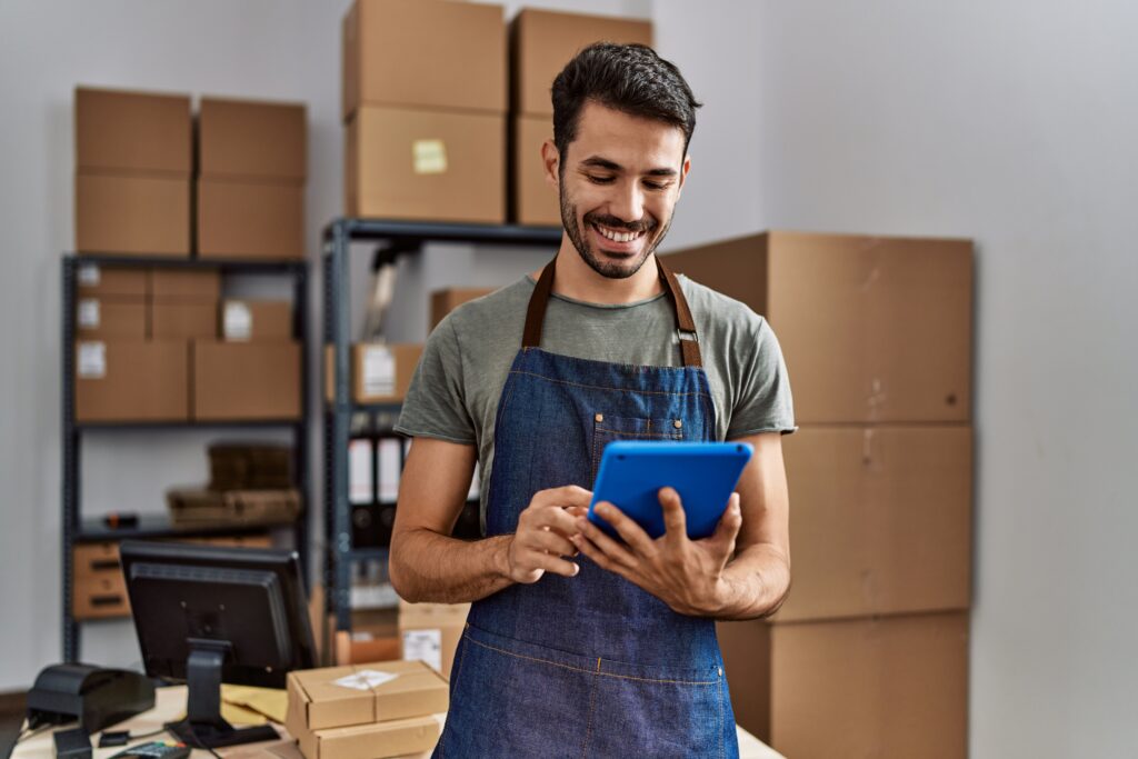 Local business owner looking confident while checking results on tablet